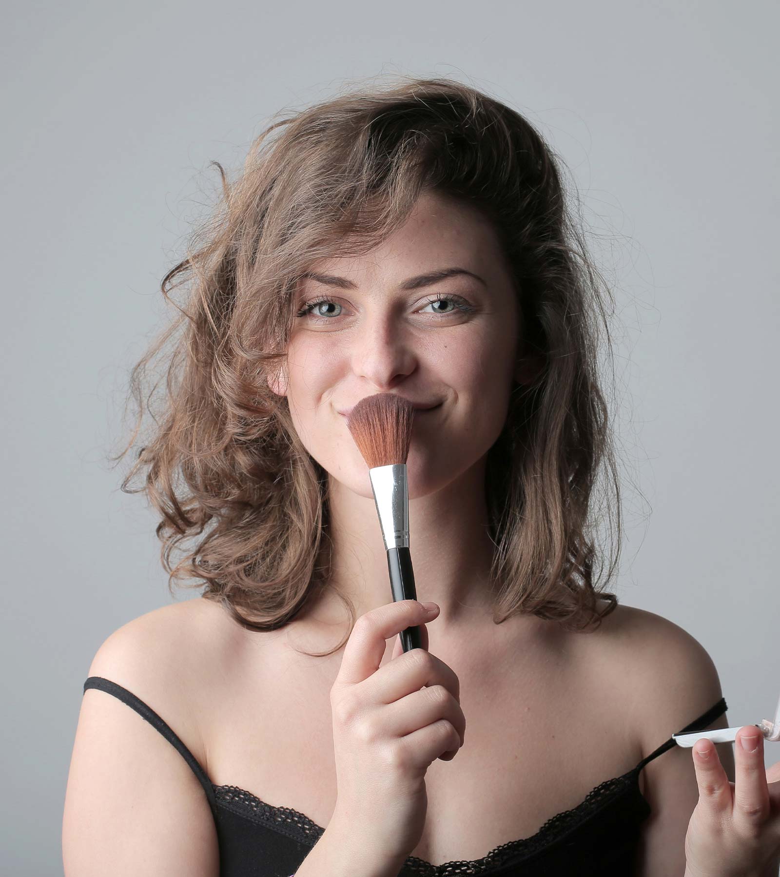 Woman holding Makeup Brush Woman holding Makeup Brush